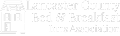 logo for Lancaster County Bed & Breakfast Inns Assocation in white; bed and breakfast home with passing buggy